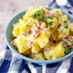 Easy no mayo potato salad with red onions, fresh herbs, and creamy dressing