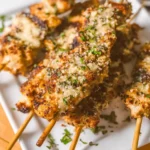 Grilled garlic parmesan ranch chicken skewers topped with parmesan cheese and fresh herbs
