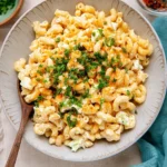 Creamy Hawaiian macaroni salad topped with paprika and fresh parsley in a serving bowl