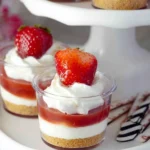 Strawberry No-Bake Cheesecake Cups layered with cheesecake filling, strawberry topping, and whipped cream
