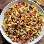 Pasta salad with cowboy caviar, black beans, corn, tomatoes, and crispy bacon
